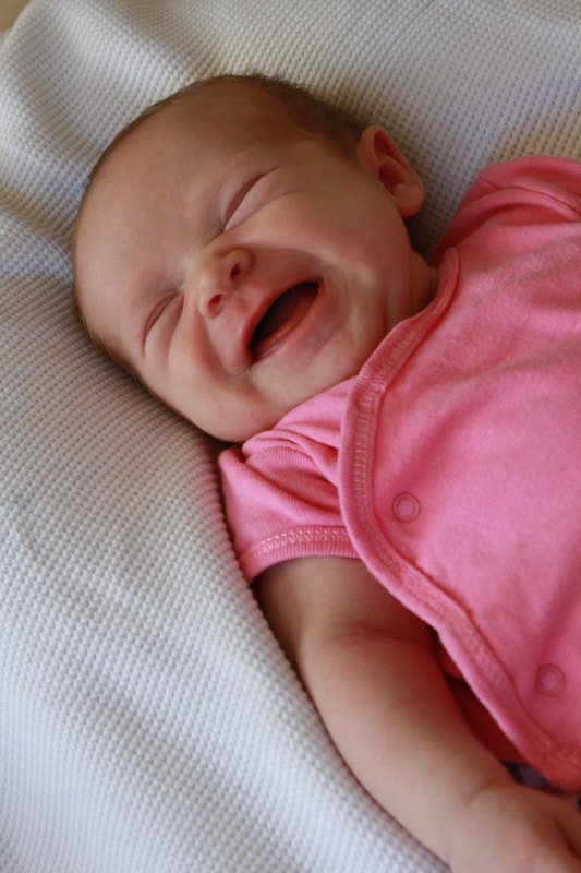 Baby in pink laughing